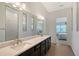 Bathroom featuring a double vanity, quartz countertops, and wood-look floors at 9028 Sunray Cv, Parrish, FL 34219