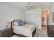 Bedroom featuring neutral decor, a ceiling fan, carpet flooring, and views to an adjoining room at 9028 Sunray Cv, Parrish, FL 34219