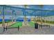 Well-maintained bocce ball courts with seating and shade, creating an enjoyable outdoor recreation area at 9028 Sunray Cv, Parrish, FL 34219