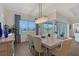 Dining room with modern chandelier, lake views and modern decor at 9028 Sunray Cv, Parrish, FL 34219