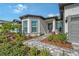 Close up view of the front entrance with stone walkway and garden at 9028 Sunray Cv, Parrish, FL 34219