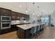 Gourmet kitchen with stainless steel appliances, large center island, and pendant lighting at 9028 Sunray Cv, Parrish, FL 34219