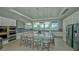 Modern kitchen with stainless steel appliances, a large island, and stylish pendant lighting at 9028 Sunray Cv, Parrish, FL 34219