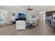 Spacious living room with tile floors, recessed lighting, tray ceilings, comfortable seating, and access to other rooms at 9028 Sunray Cv, Parrish, FL 34219