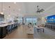 Open concept living room, dining room and kitchen with lake views at 9028 Sunray Cv, Parrish, FL 34219