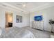 Well-lit main bedroom with neutral gray walls, carpet, and ceiling fan at 9028 Sunray Cv, Parrish, FL 34219