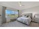 Main bedroom featuring a window with water views, a large bed, and neutral decor at 9028 Sunray Cv, Parrish, FL 34219