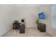 Bright office with a desk, office chair, computer, file cabinet, and a television mounted to the wall at 9028 Sunray Cv, Parrish, FL 34219