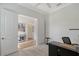 Office space showcasing an open doorway and carpet flooring, leading to additional areas within the home at 9028 Sunray Cv, Parrish, FL 34219