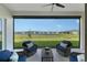 Relaxing covered patio featuring stylish seating and scenic views of the pond and backyard at 9028 Sunray Cv, Parrish, FL 34219