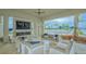 Stylish outdoor patio with comfortable seating, a fireplace, and views of the pool at 9028 Sunray Cv, Parrish, FL 34219