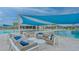 Inviting poolside lounge area with modern seating, providing a comfortable space to relax by the pool at 9028 Sunray Cv, Parrish, FL 34219