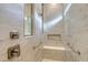 Shower with marble tile, a built-in bench, and convenient grab bars at 9028 Sunray Cv, Parrish, FL 34219