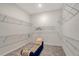 Walk-in closet with ample shelving and a comfortable bench at 9028 Sunray Cv, Parrish, FL 34219