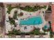 Aerial view of community pool with cabanas, lounge chairs, tables, and lush landscaping at 100 Central Ave # F912, Sarasota, FL 34236