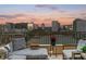 Balcony view overlooking the city with outdoor furniture, table, flower pot, and city skyline at 100 Central Ave # F912, Sarasota, FL 34236