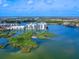 This aerial view highlights two condo buildings with picturesque greenery and beautiful water views at 10520 Boardwalk Loop # 205, Lakewood Ranch, FL 34202