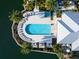 Aerial view of the waterfront pool and sun deck surrounded by landscaping at 10520 Boardwalk Loop # 205, Lakewood Ranch, FL 34202