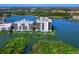 Aerial view of two condo buildings surrounded by water and lush greenery at 10520 Boardwalk Loop # 205, Lakewood Ranch, FL 34202