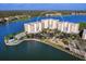 Aerial view of condo building surrounded by water with a pool, parking, and manicured landscaping at 10520 Boardwalk Loop # 205, Lakewood Ranch, FL 34202
