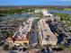 Aerial view showcases the community with upscale retail, lush landscaping, and ample parking near a scenic lake at 10520 Boardwalk Loop # 205, Lakewood Ranch, FL 34202