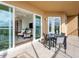 Outdoor balcony with dining set and seamless transition to the living space at 10520 Boardwalk Loop # 205, Lakewood Ranch, FL 34202