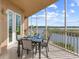 Spacious balcony with outdoor dining set and stunning waterfront views perfect for entertaining at 10520 Boardwalk Loop # 205, Lakewood Ranch, FL 34202