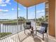 Relaxing screened-in balcony with comfortable seating and a beautiful waterfront view at 10520 Boardwalk Loop # 205, Lakewood Ranch, FL 34202