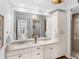 Bright bathroom boasts double sinks, granite countertops, and walk-in shower at 10520 Boardwalk Loop # 205, Lakewood Ranch, FL 34202