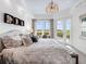 Bright bedroom features a water view, balcony, and neutral color palette at 10520 Boardwalk Loop # 205, Lakewood Ranch, FL 34202