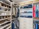Organized walk-in closet offers ample storage space for clothes, shoes, and accessories at 10520 Boardwalk Loop # 205, Lakewood Ranch, FL 34202