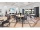 Elegant clubhouse interior with comfortable seating, fireplace, and scenic views of the outdoors at 10520 Boardwalk Loop # 205, Lakewood Ranch, FL 34202