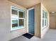 Welcoming entryway with a modern blue door and bright windows offering plenty of natural light at 10520 Boardwalk Loop # 205, Lakewood Ranch, FL 34202