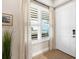 Inviting entryway featuring a white door, elegant curtains, and a green decorative plant at 10520 Boardwalk Loop # 205, Lakewood Ranch, FL 34202