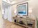 Bright hallway with a console table decorated with lamps, a large framed picture, and decorative coral at 10520 Boardwalk Loop # 205, Lakewood Ranch, FL 34202