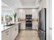 Well-lit kitchen with stainless steel appliances, granite counters, and modern white cabinetry at 10520 Boardwalk Loop # 205, Lakewood Ranch, FL 34202
