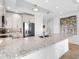 Well-lit kitchen with stainless steel appliances, ample granite counters, modern cabinetry, and a tile backsplash at 10520 Boardwalk Loop # 205, Lakewood Ranch, FL 34202