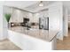 Well-lit kitchen with stainless steel appliances, ample counter space, tile backsplash, and modern white cabinetry at 10520 Boardwalk Loop # 205, Lakewood Ranch, FL 34202