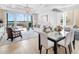 Elegant living room with a chandelier, water view, and combined living/dining room area at 10520 Boardwalk Loop # 205, Lakewood Ranch, FL 34202