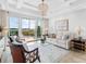 Bright living room with water view, elegant decor, comfortable seating, and natural light at 10520 Boardwalk Loop # 205, Lakewood Ranch, FL 34202