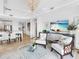 Bright living room with elegant seating, TV, and an open view of the dining area and kitchen at 10520 Boardwalk Loop # 205, Lakewood Ranch, FL 34202