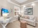 Inviting living room features a comfortable sofa, TV and lots of natural light at 10520 Boardwalk Loop # 205, Lakewood Ranch, FL 34202