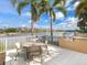 Outdoor dining area with a grill, table, and stunning waterfront views at 10520 Boardwalk Loop # 205, Lakewood Ranch, FL 34202