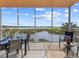 This patio features a dining set and seating with scenic water views and tile flooring at 10520 Boardwalk Loop # 205, Lakewood Ranch, FL 34202