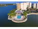 Stunning aerial view of a waterfront pool and sun deck surrounded by lush landscaping at 10520 Boardwalk Loop # 205, Lakewood Ranch, FL 34202