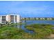 Scenic water view showcasing a condo building with balconies and beautiful surroundings at 10520 Boardwalk Loop # 205, Lakewood Ranch, FL 34202