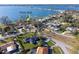 Aerial view of a coastal community featuring homes near a public park along the water, under a bright blue sky at 1103 Palma Sola Blvd, Bradenton, FL 34209