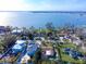 Gorgeous waterfront homes line the shore with boat docks on a sunny day, offering stunning views and direct water access at 1103 Palma Sola Blvd, Bradenton, FL 34209