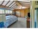 Spacious bedroom with beamed ceilings, wood paneling, multiple closets, and carpeted floors at 1103 Palma Sola Blvd, Bradenton, FL 34209
