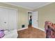 Neutral-toned bedroom with hardwood floors, large closet space, and an open doorway at 1103 Palma Sola Blvd, Bradenton, FL 34209